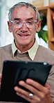 Online, happy and senior man on tablet for internet search, website and laugh for joke. Retirement, home and mature person on digital tech for news subscription, reading and relax in living room