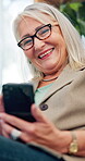 Senior woman, mobile phone and online with laugh, communication and connection for conversation. Elderly, female person and retirement on tech for chat, happiness or streaming on social media in home