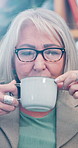 Thinking, coffee and senior woman in home for calm morning drink, comfort and peace in retirement. Relax, nostalgia and elderly person in apartment with tea cup, memory or hot beverage in living room