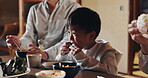 Japanese family, care and child at dinner for food, happiness and bonding together for healthy meal. People, kid and hungry for eating dumplings, diet and nutrition in dining room or house with love