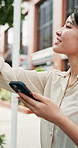 Asian woman, phone and smile in city for travel, online map and navigation app with location. Japanese girl, mobile and pointing on Tokyo sidewalk for you are here, trip planning and connectivity