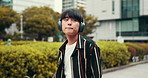 Japanese man, headphones and music in city, kpop or listening to hip hop. Asian person, radio and outdoor for sound, streaming or dancing to urban audio while walking  on commute to travel at park