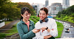 Conversation, fitness and phone with woman friends outdoor on bridge in city together for training. App, exercise tracker and pointing with Japanese sports people in urban town for communication