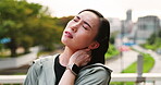 Fitness, injury and neck pain with Japanese woman in city for exercise, training or workout routine. Accident, cardio or running and sports athlete rubbing muscle in physical discomfort for emergency