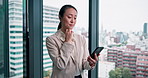 Japanese woman, phone and thinking in office for contact, networking or reading chat at corporate business. Person, smartphone or check for email, notification or choice by window at insurance agency