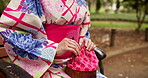Japanese woman, hands or traditional bag at park bench with lunch box for bento in garden. Kimono, culture or female person outdoor with fabric cloth, drawstring kago or fashion accessory for storage