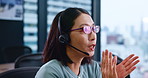 Asian woman, consultant or call center with headphones for telemarketing or customer service at office. Japanese, female person or agent with headset for telecommunications, online advice or help
