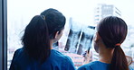 Doctors, women and xray on window for healthcare, patient results and feedback in Japanese hospital. People, radiology team and radiograph in clinic for spinal care, osteoporosis and diagnosis advice