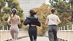 Back, women and running in city for fitness, exercise and cardio training in Tokyo. Japanese people, friends and wellness on urban bridge with energy, routine and marathon preparation with resilience