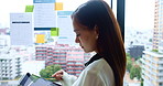 Asian, business woman and window with tablet for schedule, project planning or app at office. Japanese, female person or employee with technology for tasks, design or company development at workplace