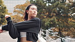 Woman, city and stretching arms for exercise, outdoor warm up and bridge for urban fitness. Female person, thinking and prepare for sports workout in town, athlete inspiration and runner in Japan