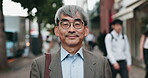 Businessman, mature and face in city for travel, commute and journey in morning to office building. Japanese employee, corporate lawyer and smile with glasses for career, trip and time lapse in Tokyo