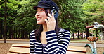 Japanese, woman and smile with phone call at park for communication, listening and contact of gossip. Happy, girl and mobile for discussion, chatting and connection for information of travel in Japan