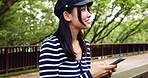 Thinking, Japanese woman and phone outdoor for communication, reading notification and social media. Girl, smile and ideas on mobile for contact, texting chat and networking of nature travel in Japan
