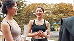 Fitness, friends and Japanese women outdoor on break after workout for body health, wellness or training. Happy group, exercise and girls talking at park for sports conversation, team gossip or smile
