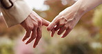 Love, date and couple holding hands in park in Japan for outdoor adventure, morning bonding and partnership. Marriage, romantic touch and people in garden with support, connection and peace in nature
