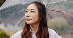 Thinking, umbrella and Asian woman in nature with rain for commute, journey and travel outdoors. Park, winter and Japanese person walking with protection for drops, splash and water in cold weather
