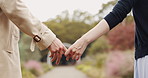 Love, date and couple holding hands in garden in Japan for outdoor adventure, morning bonding and partnership. Romance, man and woman in park together with support, connection and peace in nature