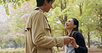 Japanese couple, holding hands and happy in park or countryside for bonding, relationship and love. Woman, man and outdoor for romance, connection and conversation with dancing on valentines day date