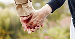 Romance, love and couple holding hands in park in Japan for outdoor date, morning bonding and partnership. Marriage, man and woman in peaceful garden with support, connection and touch in nature