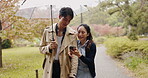 Walking, phone and Japanese couple in park for love, social media post and bonding together. Commitment, support and date with asian man and woman in nature for streaming, honeymoon and network