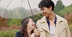 Umbrella, funny and Japanese couple in park for love, laughing and bonding together. Commitment, support and date with asian man and woman walking in nature for care, honeymoon and vacation.