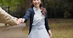 Holding hands, smile and Japanese couple in park for love, partner and bonding together. Commitment, walk and happy with asian man and woman on date in nature path for care, honeymoon and vacation