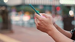 City, hands and scroll with smartphone outdoor at night for playing online game and browsing social media. Japanese person, phone or internet search for travel schedule and web information with bokeh