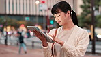 Business, smile and tablet with Japanese woman outdoor in city for break, email or research. Internet, technology and traffic with happy Asian employee reading information online on busy street