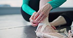 Woman, hands and ballerina tying with shoe for dance class, rehearsal or practice on floor at studio. Japanese, closeup or female person with feet, ankle strap or getting ready for ballet dancing