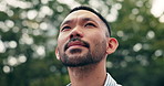 Thinking, outdoor and Japanese man in city with idea, reflection and nostalgia for remembrance. Wonder, inspiration and low angle of Asian male person with decision, choice or memory in urban town.