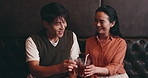 Japanese, couple and drinks in restaurant for toast, anniversary celebration and love in relationship. Happy people, man and woman with beverage for cheers, connection and bonding together on date