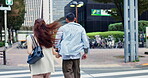 Japanese couple, back and holding hands with crosswalk in city, street and excited for travel and vacation or care. Man, woman and together with adventure, support and love on holiday in Tokyo