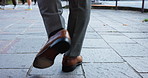 Sidewalk, shoes and businessman with walking, for journey, commute and travel to workplace by back. Closeup, corporate employee and person legs in morning for movement, location and downtown in Japan
