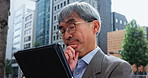 Mature business man, thinking and tablet in city for planning, brainstorming and innovation in Japan. Asian architect, glasses and tech in Tokyo for problem solving with ideas for urban development
