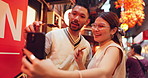 Asian couple, selfie and street food with skewers or kebabs for traditional or local cuisine in Japan. Japanese, man and woman with picture, photography or memory for omoide yokocho together in Tokyo