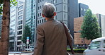 Walking, business and back of Asian man in city thinking on morning commute, travel and journey. Professional, architecture and Japanese person in town by building for career, job and inspiration
