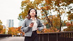 Japanese, woman and late outdoor on park bridge with phone checking for time and rush to job in city. Urban, professional and Tokyo with run for appointment and work schedule in morning and autumn