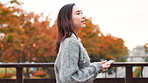 Urban, bridge and woman with phone, walking and typing on social media on with morning commute. Smartphone, smile and girl with mobile app, online chat or location search for city travel in Japan