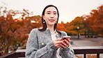 City, park and face of woman with phone, smile and confidence on morning commute. Smartphone, happy and Japanese girl on bridge with mobile app for social media, online chat and outdoor urban travel