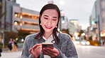 Smile, typing and woman in city with smartphone, connection or online chat on morning commute. Phone, search and Japanese girl in street on mobile app for social media, communication and urban travel