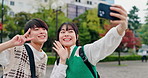 Travel, selfie and Asian couple with peace sign in city for holiday, bonding and dating on weekend. Love, happy and Japanese man and woman with emoji take photo for social media, memory and post