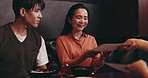 Couple, smile and menu in Japanese restaurant for customer service, fine dining or thank you. Asian man, woman or paper in ramen cafe for food, dessert order or luxury meal with respect communication