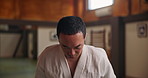 Face, confident Asian man or bow in dojo for respect, karate practice and self defense in class. Portrait, honor or student in Japan for learning martial arts, combat training or workout for fighting