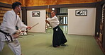Sensei, student and bokken for fight, aikido and martial arts with fitness, kung fu and stick in Japan. Training, teaching and master for karate, battle and self defense class with exercise in dojo