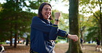 Fitness, smile and stretching with man in forest for start of cardio, training or workout routine. Exercise, getting ready and warm up with happy Japanese athlete outdoor in nature or park for sports