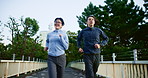 Fitness, Asian people or running in city for exercise, wellness or cardio workout in Japan. Happy, couple or energy on Tokyo bridge for training commitment, healthy relationship or support for growth