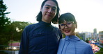 Japanese couple, face and happy outdoor, date and hug together with partner on bridge at sunset. Asian man, woman and portrait in city for travel, support and romantic connection for love in Tokyo