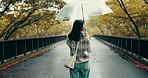 Walking, back or Asian woman on road with umbrella in park in Japan culture for tourism. Protection, girl or Japanese person in urban town for travel view or sightseeing on outdoor holiday adventure