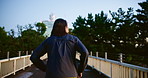 Japanese person, back and running with city, morning and street or bridge for fitness or workout. Athlete, man and exercise on Tokyo road for wellness, health and marathon training performance